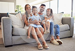 Parents, kids and happy family home portrait on living room sofa, couch and lounge to relax, quality time and fun