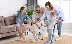 Parents and kids having fun with dog at home