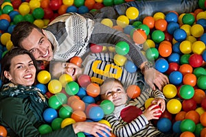 Parents and kids playing in the pool with colorful balls