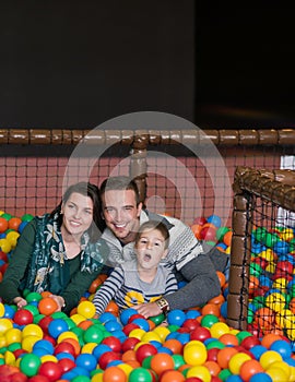 Parents and kids playing in the pool with colorful balls