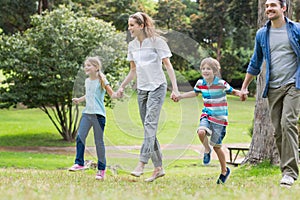 Parents and kids walking in park