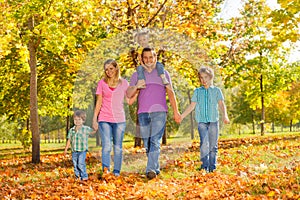 Parents and kids walking together holding hands