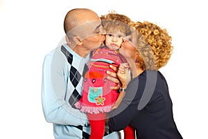 Parents kissing pouting daughter