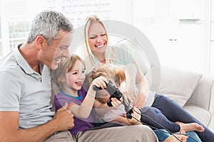 Parents looking at children playing video game