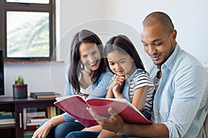 Parents looking daughter exercise book