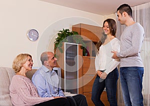 Parents meeting girlfriend of their son at home in the everning photo
