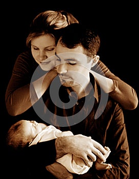 Parents with newborn baby in sepia