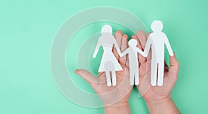 Parents with one child holding hands, paper cut out, family, copy space for text