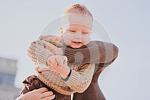 Parents play with their child close-up. Boy flying and laughing, happy family