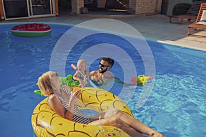 Parents playing with child at the swimming pool