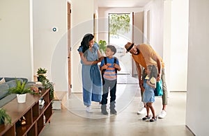 Parents Saying Goodbye To Children As They Leave Home For School