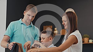 Parents and schoolboy preparing to school