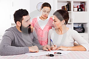 Parents signing papers for divorce