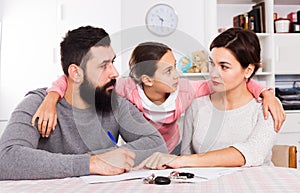 Parents signing papers for divorce