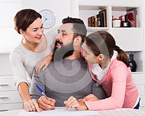 Parents signing property papers