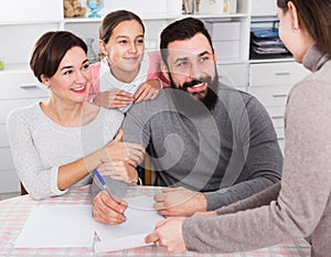 Parents signing property papers