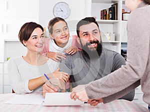 Parents signing property papers