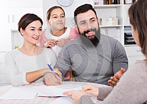 Parents signing property papers