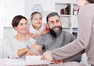 Parents signing property papers