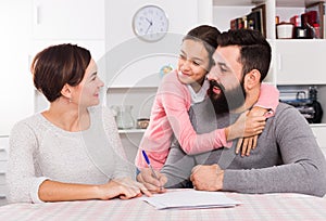 Parents signing property papers