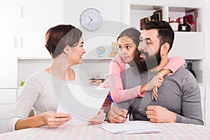 Parents signing property papers