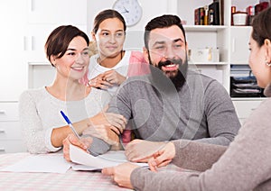 Parents signing property papers