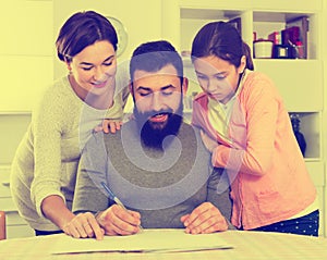 Parents signing property papers