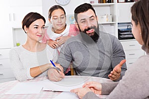 Parents signing property papers