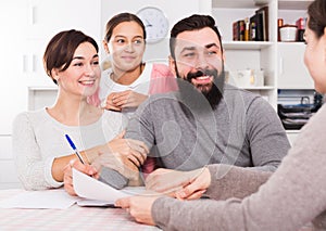 Parents signing property papers