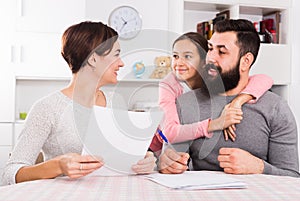 Parents signing property papers