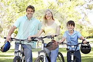 Parents And Son On Cycle Ride In Park