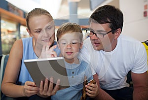 Parents and son with tablet PC at the airport