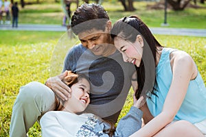 Parents take care daughter in the park