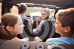 Parents Taking Children On Trip In Open Top Car