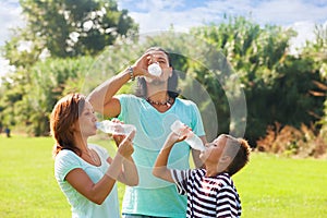 Parents with teenager drinking cold water