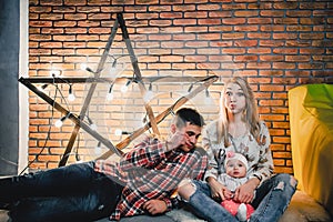 parents with their child on the background of a star with bulbs
