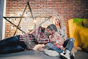 parents with their child on the background of a star with bulbs