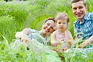 Parents and their daughter in grass