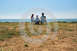 Parents and their kid sitting together at capmsite outdoors