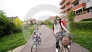 Parents With Their Kids Are Riding On Bikes. Happy Family Spending Time Together.