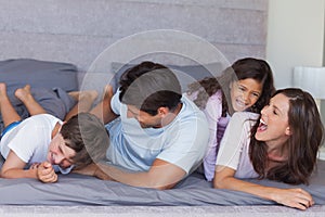 Parents tickling their children