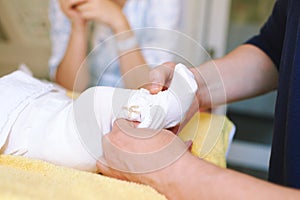 Parents together dressing newborn baby