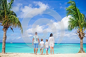 Parents with two kids enjoy their caribbean vacation on Antigua island