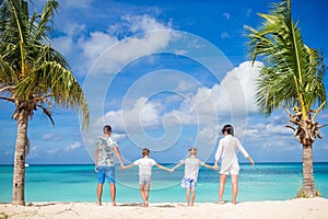 Parents with two kids enjoy their caribbean vacation on Antigua island