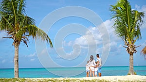 Parents with two kids enjoy their caribbean vacation on Antigua island