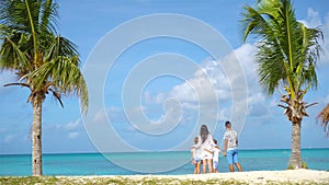 Parents with two kids enjoy their caribbean vacation on Antigua island