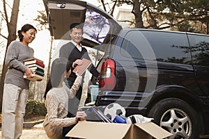 Parents unpacking car for a move to college, Beijing