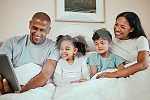 Parents watching a movie on a tablet with their kids in the bed to relax, rest and bond. Happy, smile and children