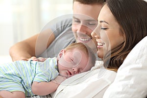 Parents watching their baby sleeping