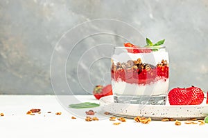 Parfait with yogurt, granola, jam, fresh berries and mint leaves in glass jar. gluten free diet, Healthy breakfast. banner, menu,